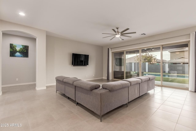 tiled living room featuring ceiling fan