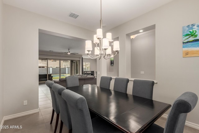 dining room featuring light tile patterned flooring and ceiling fan with notable chandelier