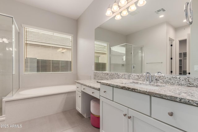 bathroom with tile patterned floors, vanity, and plus walk in shower