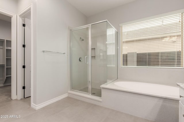 bathroom with tile patterned flooring, shower with separate bathtub, and vanity