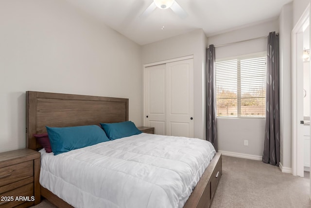 bedroom featuring light carpet, ceiling fan, and a closet