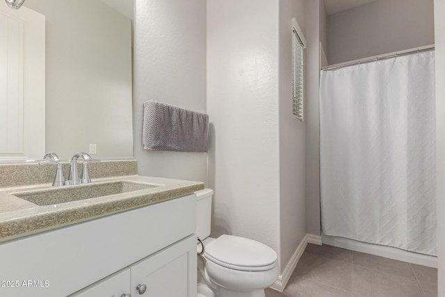 bathroom featuring tile patterned flooring, vanity, and toilet