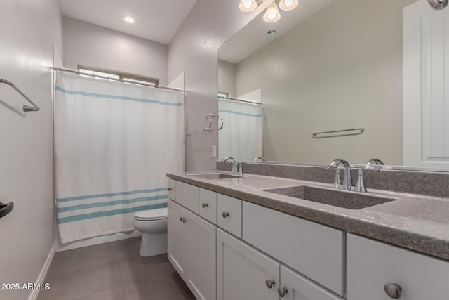 bathroom featuring vanity, tile patterned floors, and toilet