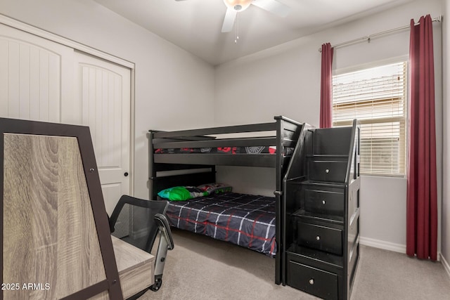 bedroom featuring ceiling fan, a closet, and light carpet