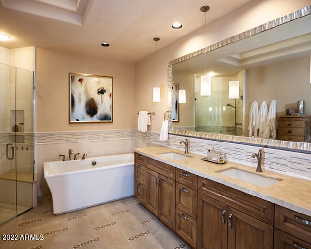 bathroom featuring vanity, tile patterned floors, separate shower and tub, and tile walls