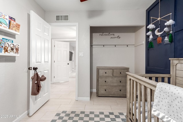 tiled bedroom featuring a crib