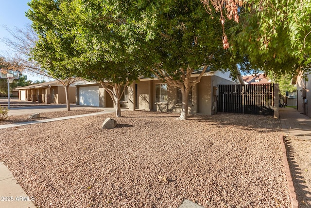 view of property hidden behind natural elements featuring a garage