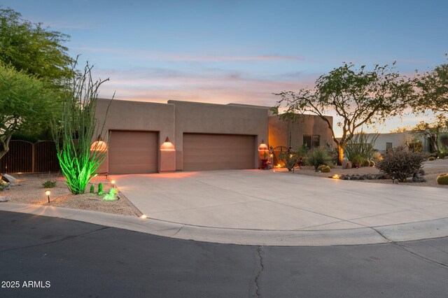 11299 E Greythorn Dr, Scottsdale, AZ 85262 - pueblo-style house with stucco siding, concrete driveway, and a garage