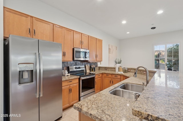 11299 E Greythorn Dr, Scottsdale, AZ 85262 - kitchen with appliances with stainless steel finishes, light stone counters, decorative backsplash, recessed lighting, and a peninsula