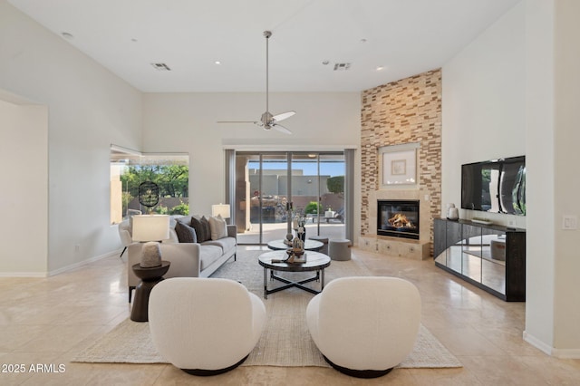 11299 E Greythorn Dr, Scottsdale, AZ 85262 - living room featuring a towering ceiling, light tile patterned floors, ceiling fan, a large fireplace, and recessed lighting