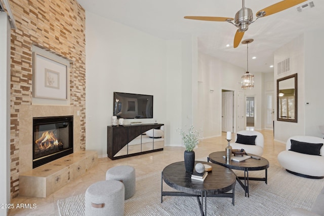 11299 E Greythorn Dr, Scottsdale, AZ 85262 - living area with a ceiling fan, a large fireplace, a high ceiling, tile patterned floors, and recessed lighting