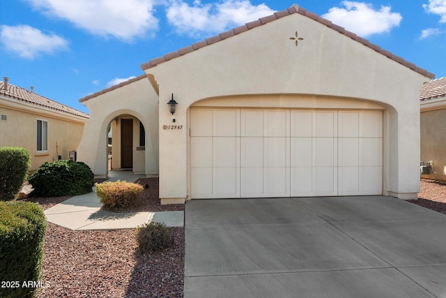 mediterranean / spanish home with a garage