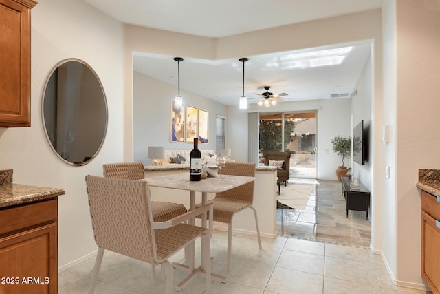 dining space featuring light tile patterned floors and ceiling fan