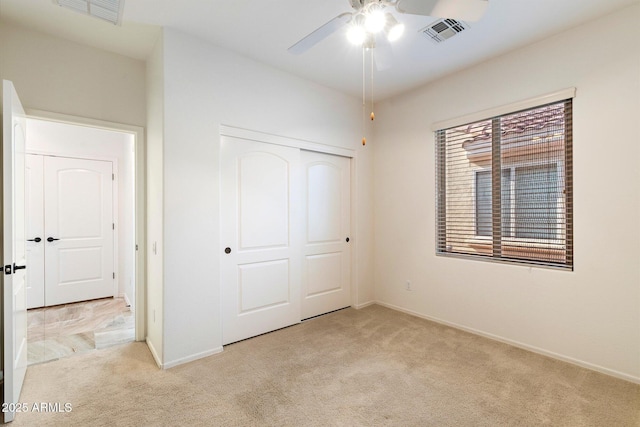 unfurnished bedroom with ceiling fan, a closet, and light colored carpet