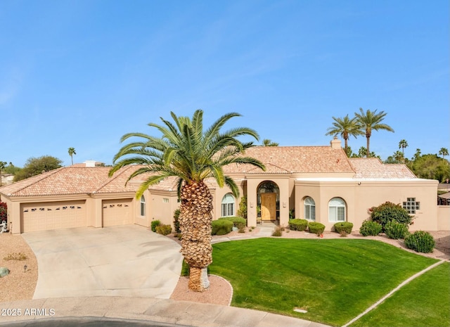 mediterranean / spanish-style home featuring driveway, stucco siding, a front lawn, a garage, and a tiled roof