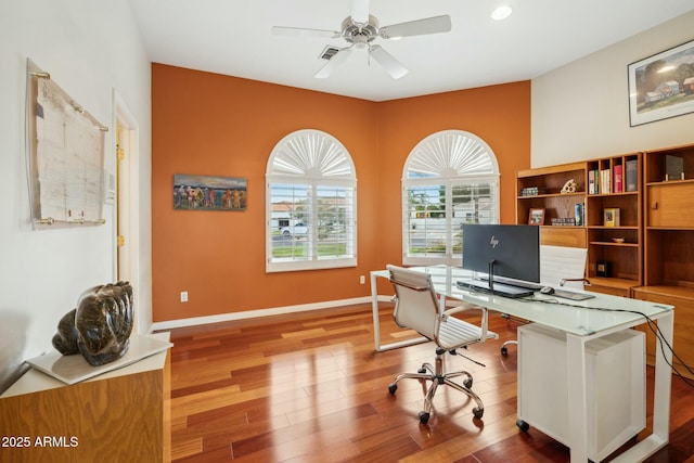 office area featuring ceiling fan, baseboards, and wood finished floors