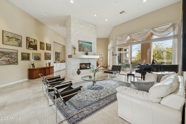 living room with visible vents, high vaulted ceiling, recessed lighting, a stone fireplace, and baseboards