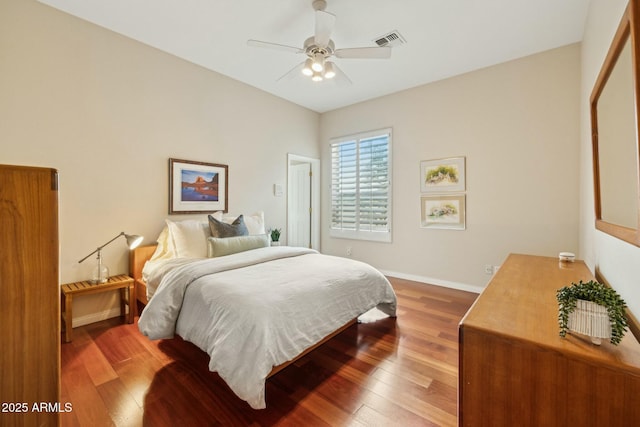 bedroom featuring hardwood / wood-style flooring, baseboards, visible vents, and ceiling fan