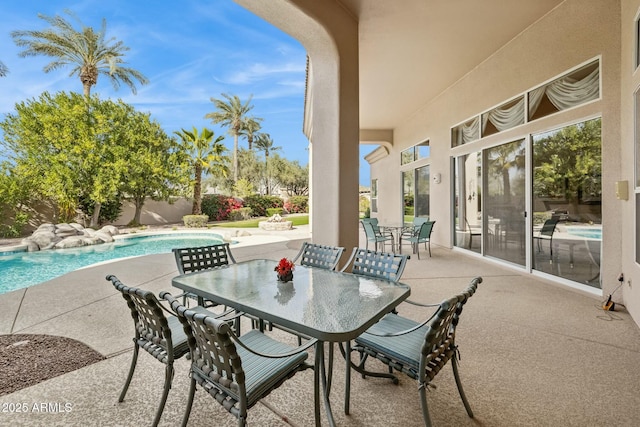 view of patio featuring outdoor dining area, a fenced in pool, and a fenced backyard