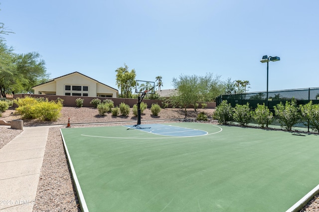 view of sport court with fence and basketball court