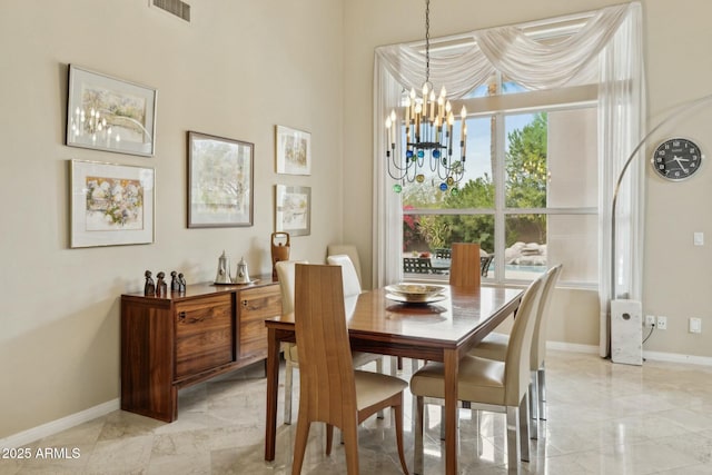 dining room featuring an inviting chandelier, visible vents, marble finish floor, and baseboards