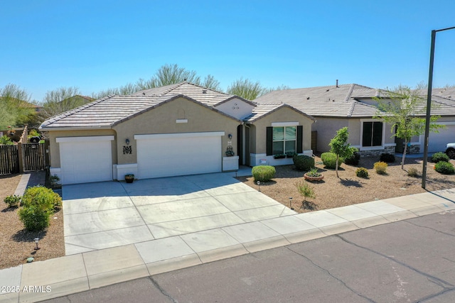 ranch-style home featuring stucco siding, driveway, an attached garage, and a tile roof