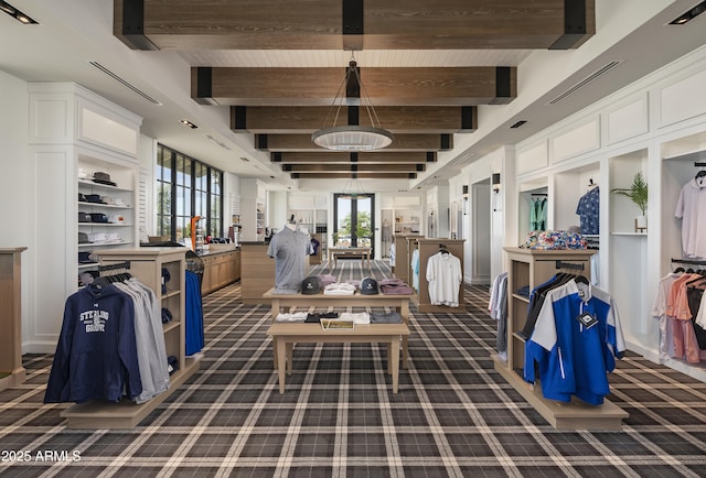 interior space with visible vents, beamed ceiling, and carpet flooring