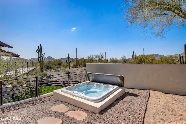 view of patio / terrace with a mountain view and a covered hot tub