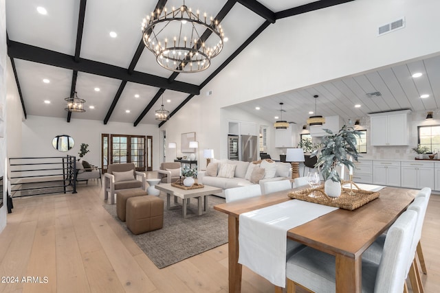 living room featuring beam ceiling, a chandelier, light hardwood / wood-style floors, and high vaulted ceiling