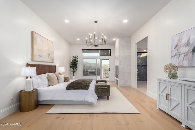 bedroom featuring light hardwood / wood-style floors and an inviting chandelier