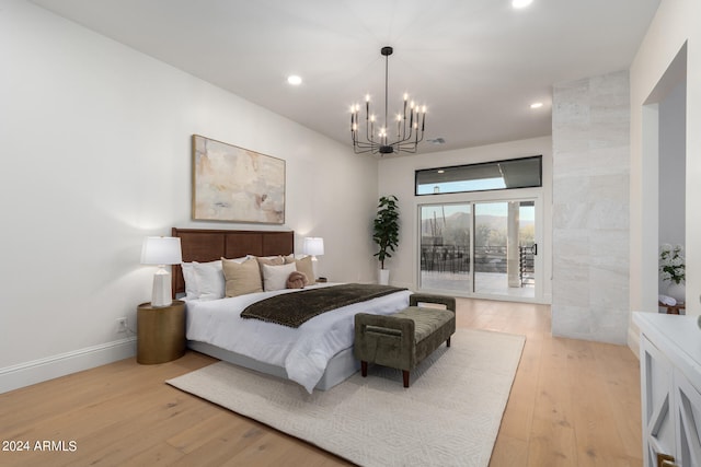 bedroom featuring light hardwood / wood-style flooring, a chandelier, and access to exterior