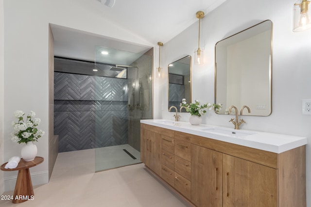 bathroom featuring a tile shower, tile patterned flooring, and vanity