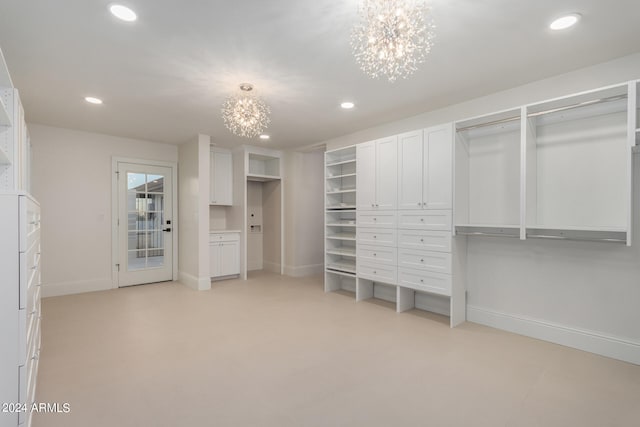 walk in closet featuring a chandelier