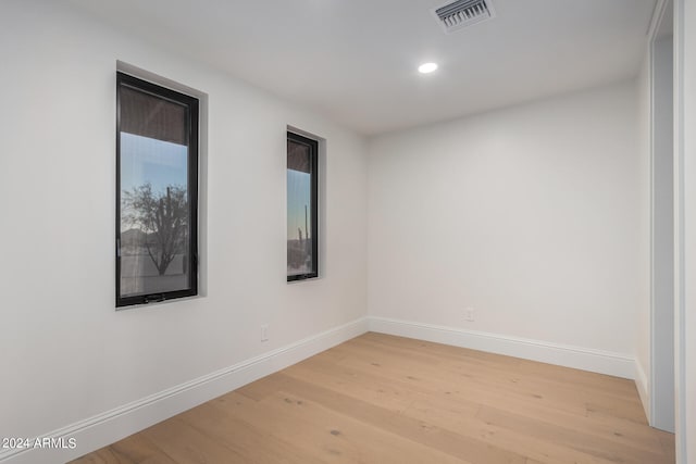 empty room with hardwood / wood-style flooring