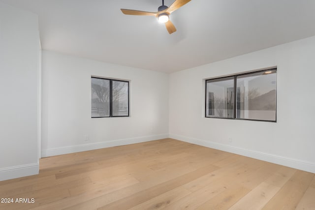 spare room with ceiling fan and hardwood / wood-style flooring