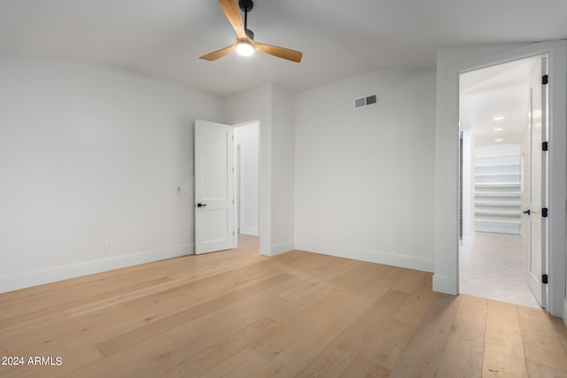 spare room featuring light hardwood / wood-style flooring and ceiling fan