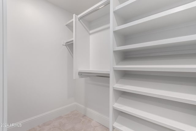 spacious closet with light tile patterned flooring