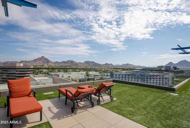 view of patio with a mountain view and a balcony