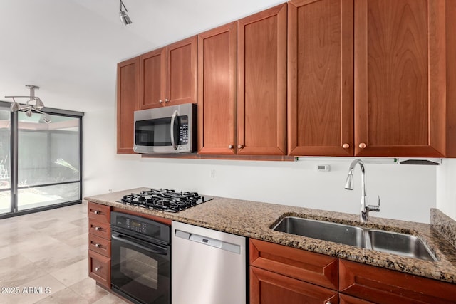 kitchen with black appliances, a sink, light stone countertops, and brown cabinetry