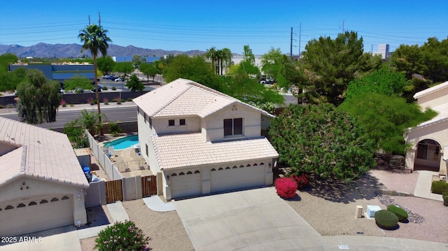 view of front of house with fence, stucco siding, concrete driveway, an attached garage, and a tile roof