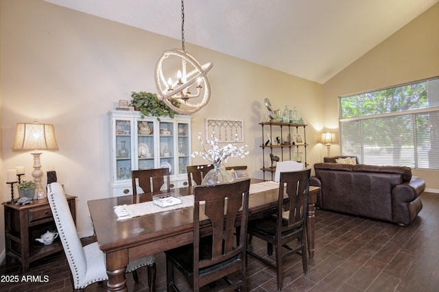 dining space with baseboards, dark wood finished floors, a notable chandelier, and high vaulted ceiling