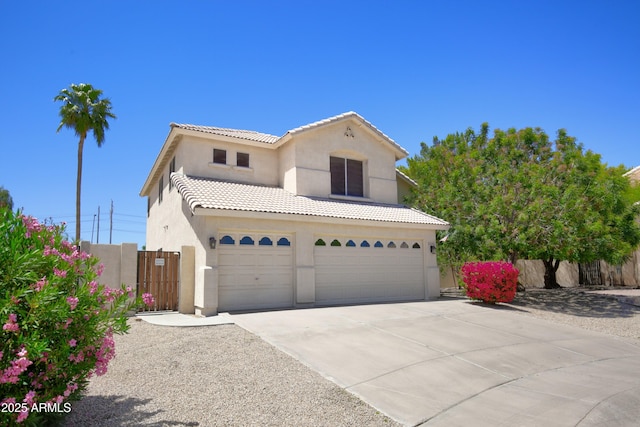 traditional-style home featuring fence, an attached garage, stucco siding, concrete driveway, and a tiled roof