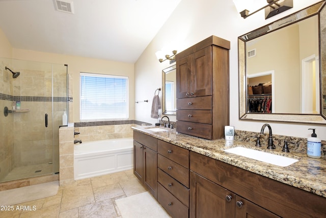 full bathroom featuring a sink, a shower stall, and visible vents
