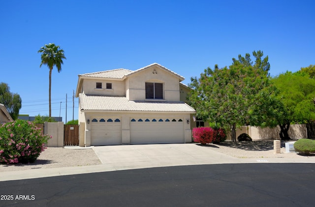 traditional-style home with a garage, fence, stucco siding, a tiled roof, and concrete driveway