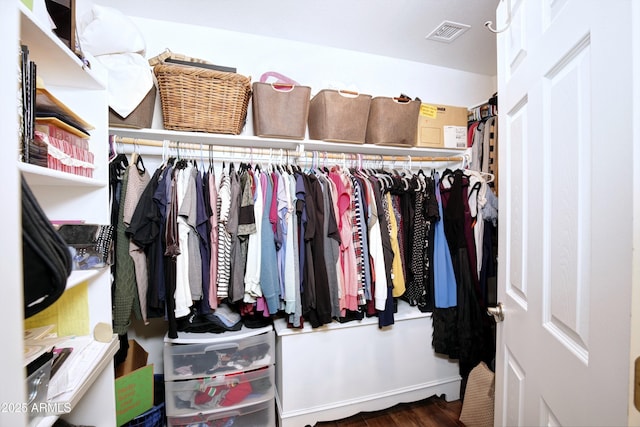 walk in closet with visible vents and wood finished floors