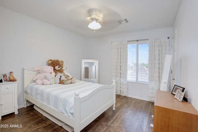 bedroom featuring visible vents, a ceiling fan, and dark wood finished floors