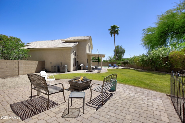 view of patio with a fenced backyard and an outdoor fire pit