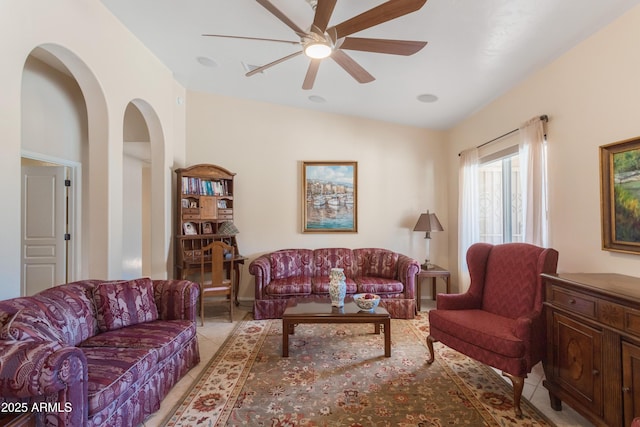 living room with light tile patterned flooring and a ceiling fan