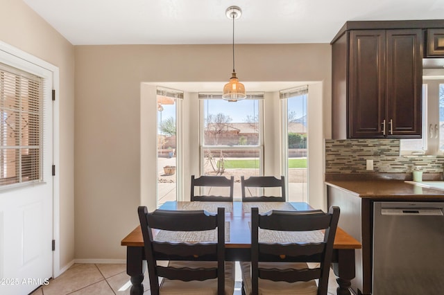 dining space with light tile patterned floors and baseboards