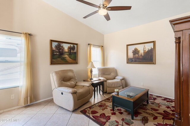 living room with baseboards, lofted ceiling, light tile patterned flooring, and a ceiling fan